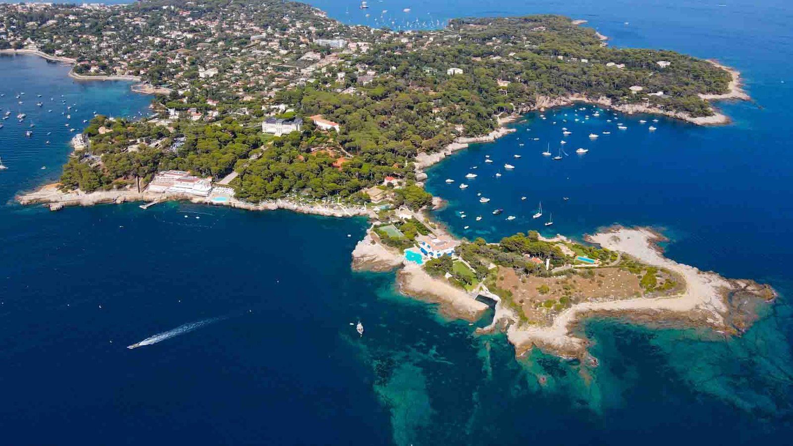 Aerial view of Cap d'Antibes and  Billionaire's Bay. Plage de l'argent faux. Beautiful rocky beach near coastal path on the Cap d'Antibes, Antibes, France. Drone view of Côte d’Azur.