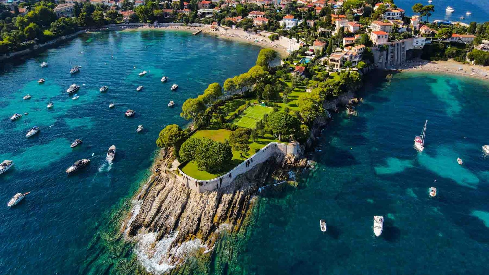 Aerial drone view of Saint-Jean-Cap-Ferrat, French Riviera (Côte d'Azur), France. Birds Eye view of the French Riviera resort town on Cap Ferrat cape with exclusive estates in a perched village.